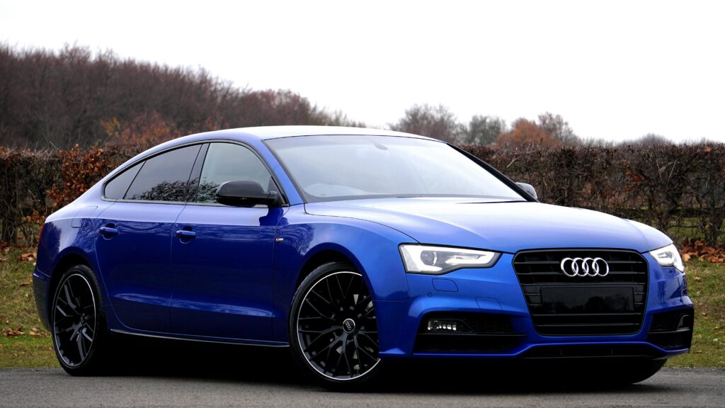 pexels-photo-244206-244206 Elegant blue luxury car parked outdoors against a natural backdrop.